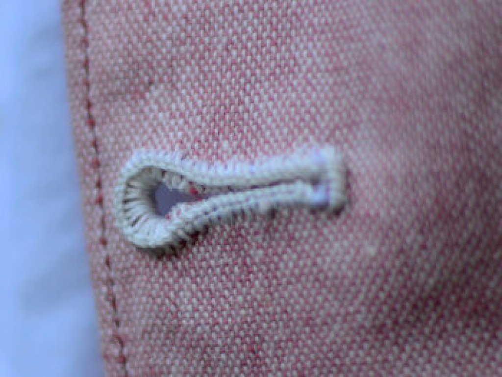 Buttonhole sewn by hand.