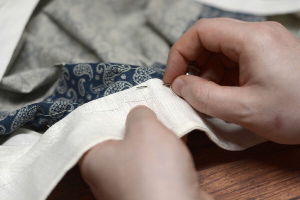 Sewing on a shirt collar.