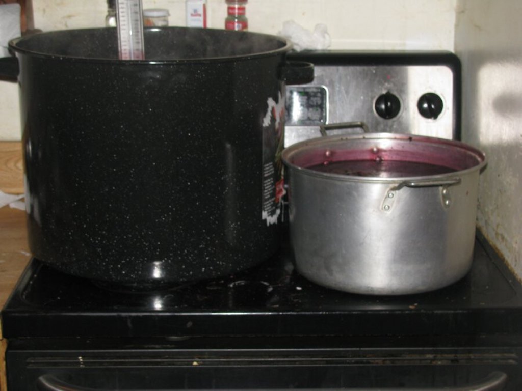 Two pots of dye on stove.