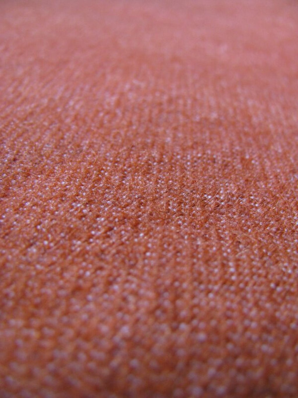Close up of wool fabric dyed with natural madder root.