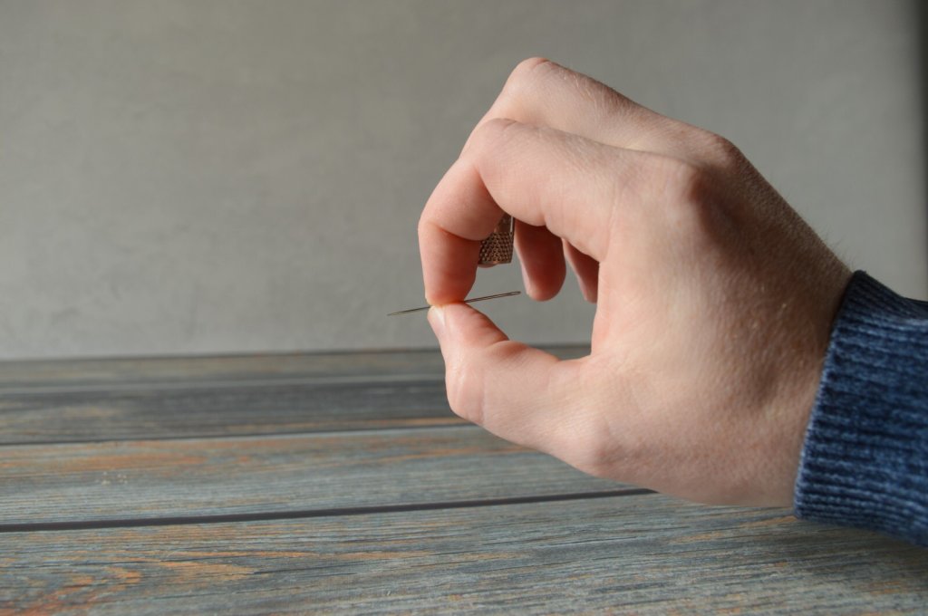 Practice using your needle with the tailor's thimble.