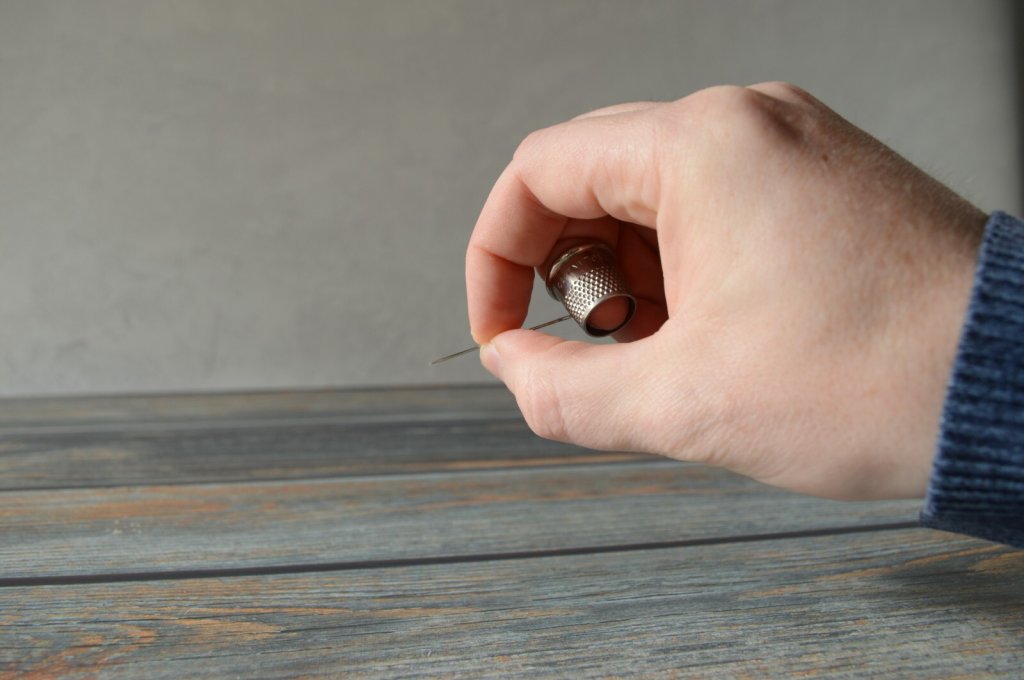 Practice using your needle with the tailor's thimble.
