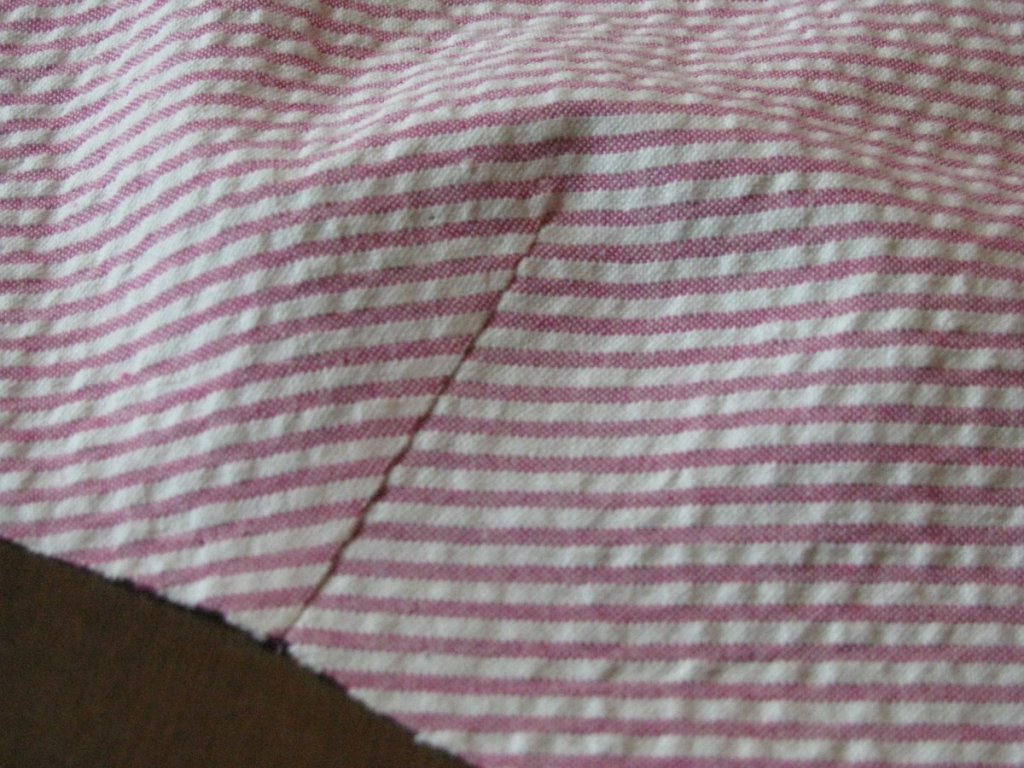 A dart sewn in fabric.