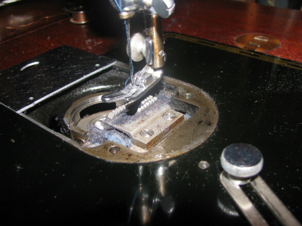 Lint clogging a sewing machine.