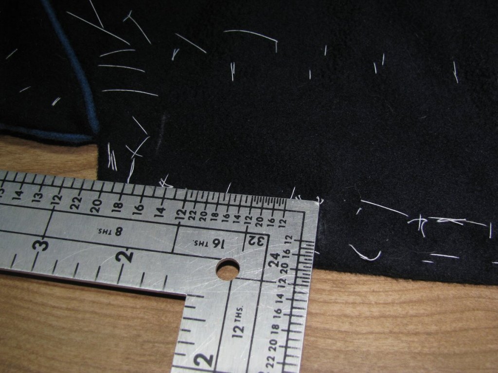 Spacing the buttonholes with a tailor's square.