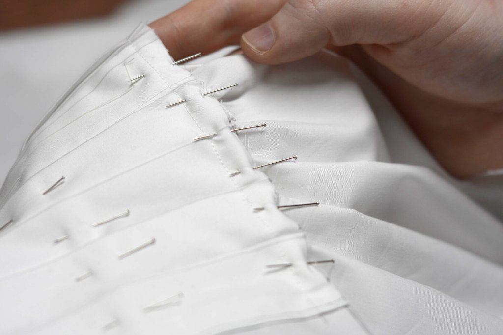 Pin the pleated front to the shirt.